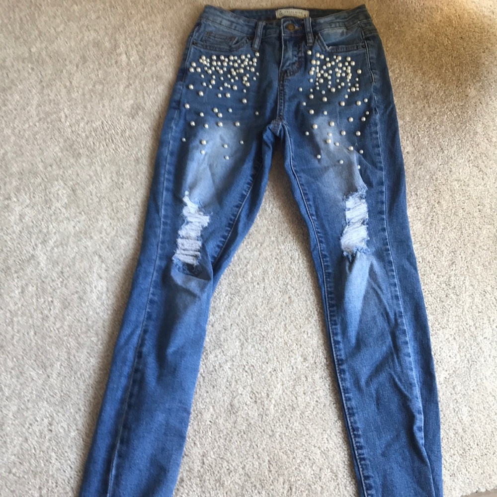 Ripped jeans with pearls on them